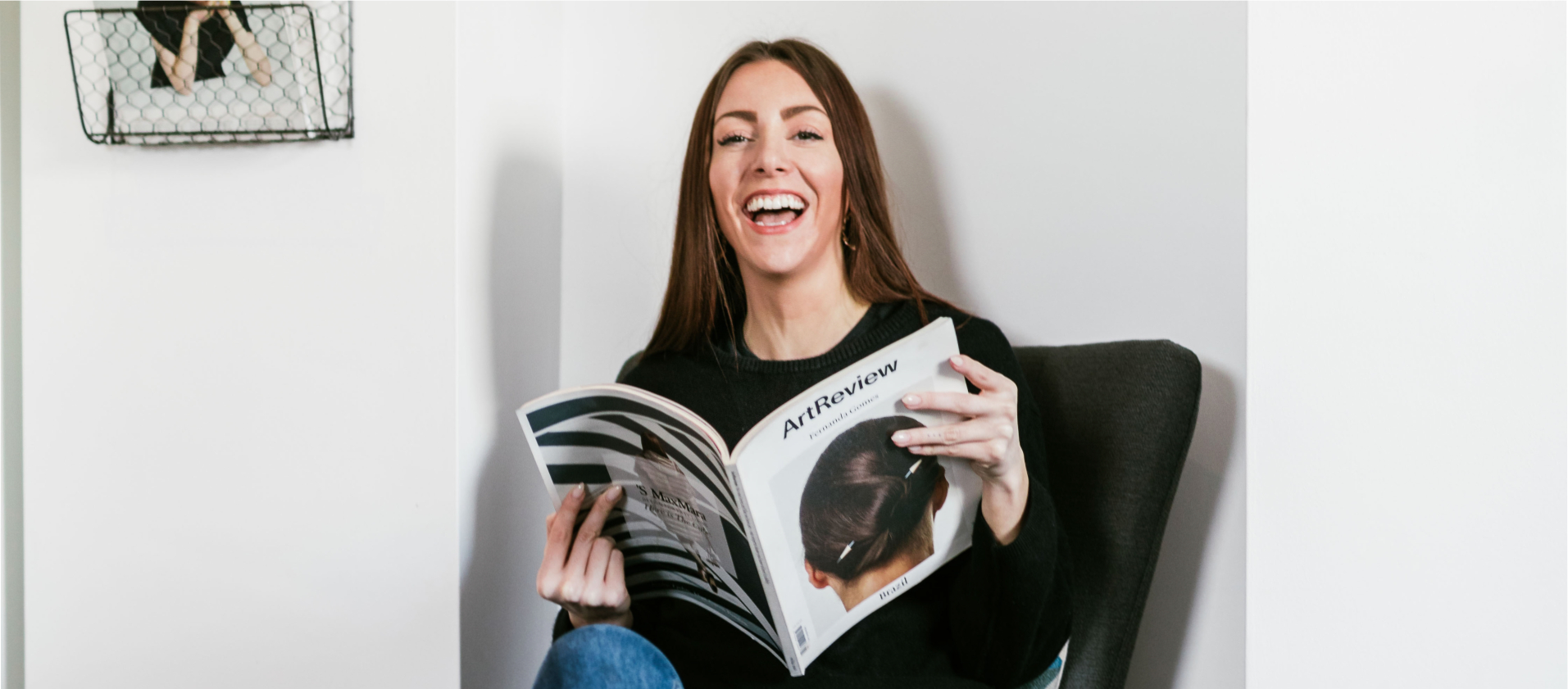A photo of Claire Holly smiling and holding a magazine. Claire Holly offers brand coaching for female founders.